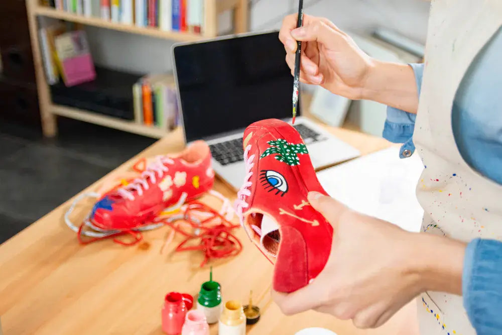 Artist working on crafts and utilizing storage in Singapore to keep creative materials neatly arranged.