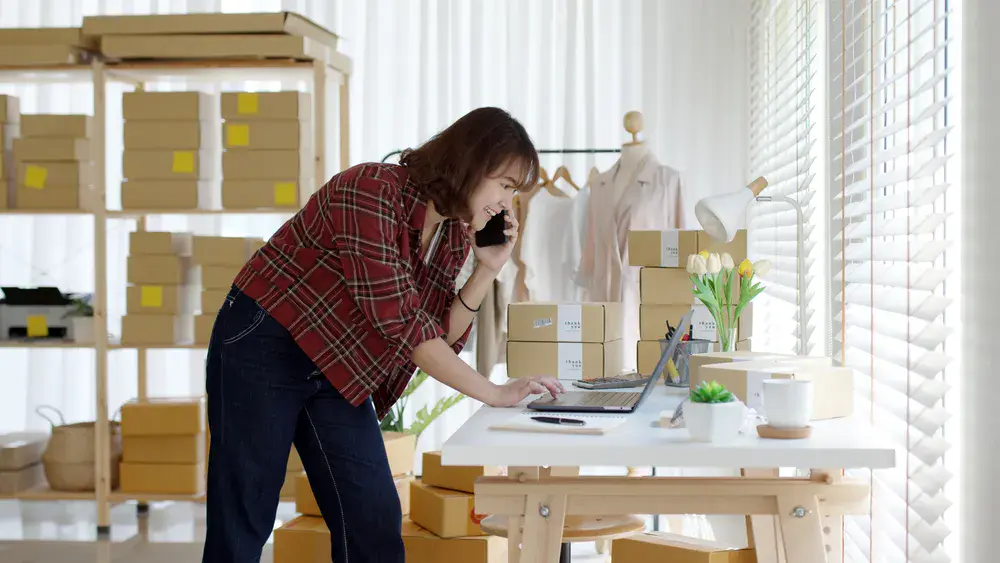 Small business owner using storage in Singapore to keep online shop inventory safe and organized.